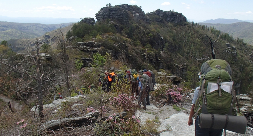 a group of people wearing backpacks hike along a trail in the blue ridge mountains 